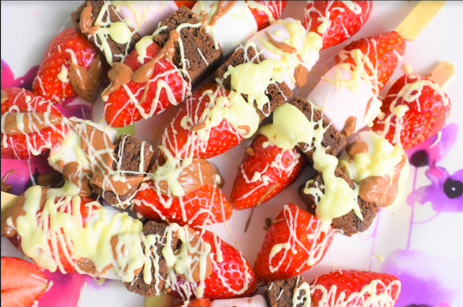 Super easy and yummy Valentines Skewers which the little ones will love! Brownies, strawberries, marshmallows and melted chocolate, just the best combination. No baking required so the clean up is quick! Perfect for your kiddos to make on the day for you all to enjoy. These really are delish so don’t expect there to be any leftovers! Ingredients (to make 8 skewers) Small skewers (or cut the longer ones in half) 100g of milk chocolate 100g of white chocolate 8 ready made brownies (bite size) 8 large marshmallows 8 strawberries (cut in half) Instructions Firstly, cut the end off your strawberries and then slice in half. Next, pop half a strawberry, a brownie, a marshmallow and the other half of the strawberry through the skewer. Little ones may like to put on in any order to make them all slightly different. Break the chocolate up into smaller chunks and put in two seperate microwavable bowls, one for the milk chocolate and one for the white. Pop both bowls side by side in the microwave on a low setting until the chocolate has melted. Make sure to stop and stir regularly. Here comes the fun part! Let your kids go wild with drizzling (or dolloping) both chocolates over all the skewers, the messier the better! You will have leftover melted chocolate which you can now dip the skewers in and enjoy. Chocolate overload… yum! If you have any skewers left over (we didn’t - they were gobbled up quickly) you could transfer the remaining skewers into the fridge and the chocolate will set and harden to enjoy at a later time. 