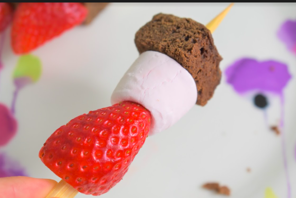 Super easy and yummy Valentines Skewers which the little ones will love! Brownies, strawberries, marshmallows and melted chocolate, just the best combination. No baking required so the clean up is quick! Perfect for your kiddos to make on the day for you all to enjoy. These really are delish so don’t expect there to be any leftovers! Ingredients (to make 8 skewers) Small skewers (or cut the longer ones in half) 100g of milk chocolate 100g of white chocolate 8 ready made brownies (bite size) 8 large marshmallows 8 strawberries (cut in half) Instructions Firstly, cut the end off your strawberries and then slice in half. Next, pop half a strawberry, a brownie, a marshmallow and the other half of the strawberry through the skewer. Little ones may like to put on in any order to make them all slightly different. Break the chocolate up into smaller chunks and put in two seperate microwavable bowls, one for the milk chocolate and one for the white. Pop both bowls side by side in the microwave on a low setting until the chocolate has melted. Make sure to stop and stir regularly. Here comes the fun part! Let your kids go wild with drizzling (or dolloping) both chocolates over all the skewers, the messier the better! You will have leftover melted chocolate which you can now dip the skewers in and enjoy. Chocolate overload… yum! If you have any skewers left over (we didn’t - they were gobbled up quickly) you could transfer the remaining skewers into the fridge and the chocolate will set and harden to enjoy at a later time. 