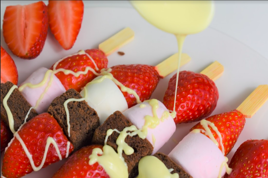 Super easy and yummy Valentines Skewers which the little ones will love! Brownies, strawberries, marshmallows and melted chocolate, just the best combination. No baking required so the clean up is quick! Perfect for your kiddos to make on the day for you all to enjoy. These really are delish so don’t expect there to be any leftovers! Ingredients (to make 8 skewers) Small skewers (or cut the longer ones in half) 100g of milk chocolate 100g of white chocolate 8 ready made brownies (bite size) 8 large marshmallows 8 strawberries (cut in half) Instructions Firstly, cut the end off your strawberries and then slice in half. Next, pop half a strawberry, a brownie, a marshmallow and the other half of the strawberry through the skewer. Little ones may like to put on in any order to make them all slightly different. Break the chocolate up into smaller chunks and put in two seperate microwavable bowls, one for the milk chocolate and one for the white. Pop both bowls side by side in the microwave on a low setting until the chocolate has melted. Make sure to stop and stir regularly. Here comes the fun part! Let your kids go wild with drizzling (or dolloping) both chocolates over all the skewers, the messier the better! You will have leftover melted chocolate which you can now dip the skewers in and enjoy. Chocolate overload… yum! If you have any skewers left over (we didn’t - they were gobbled up quickly) you could transfer the remaining skewers into the fridge and the chocolate will set and harden to enjoy at a later time. 